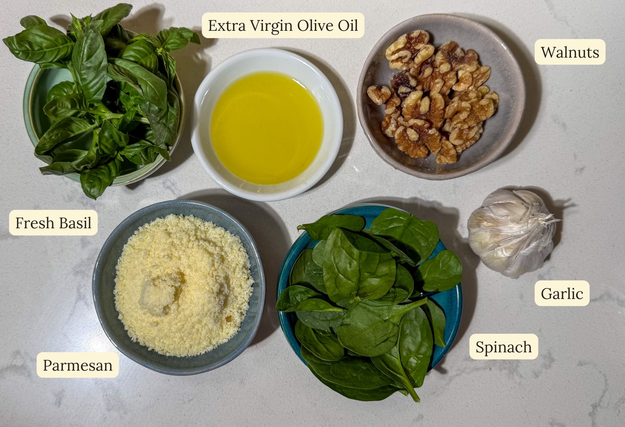 all ingredients laid out on a table for spinach walnut pesto without pine nuts