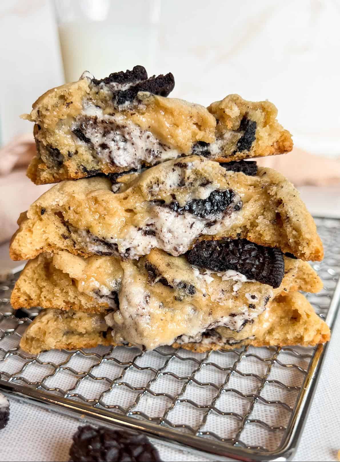 Oreo Cheesecake Cookies (Stuffed!) 2 Oreo cheesecake cookies halved then stacked on top of each other to reveal the cheesecake center