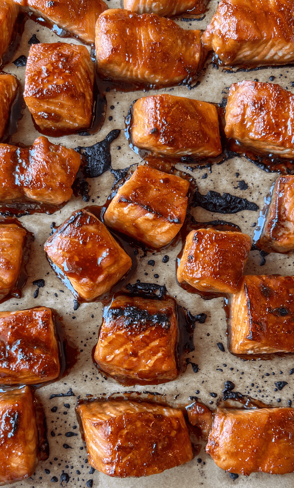 Orange Sesame Salmon Bites 8 Broiled glazed salmon bites on a sheet tray