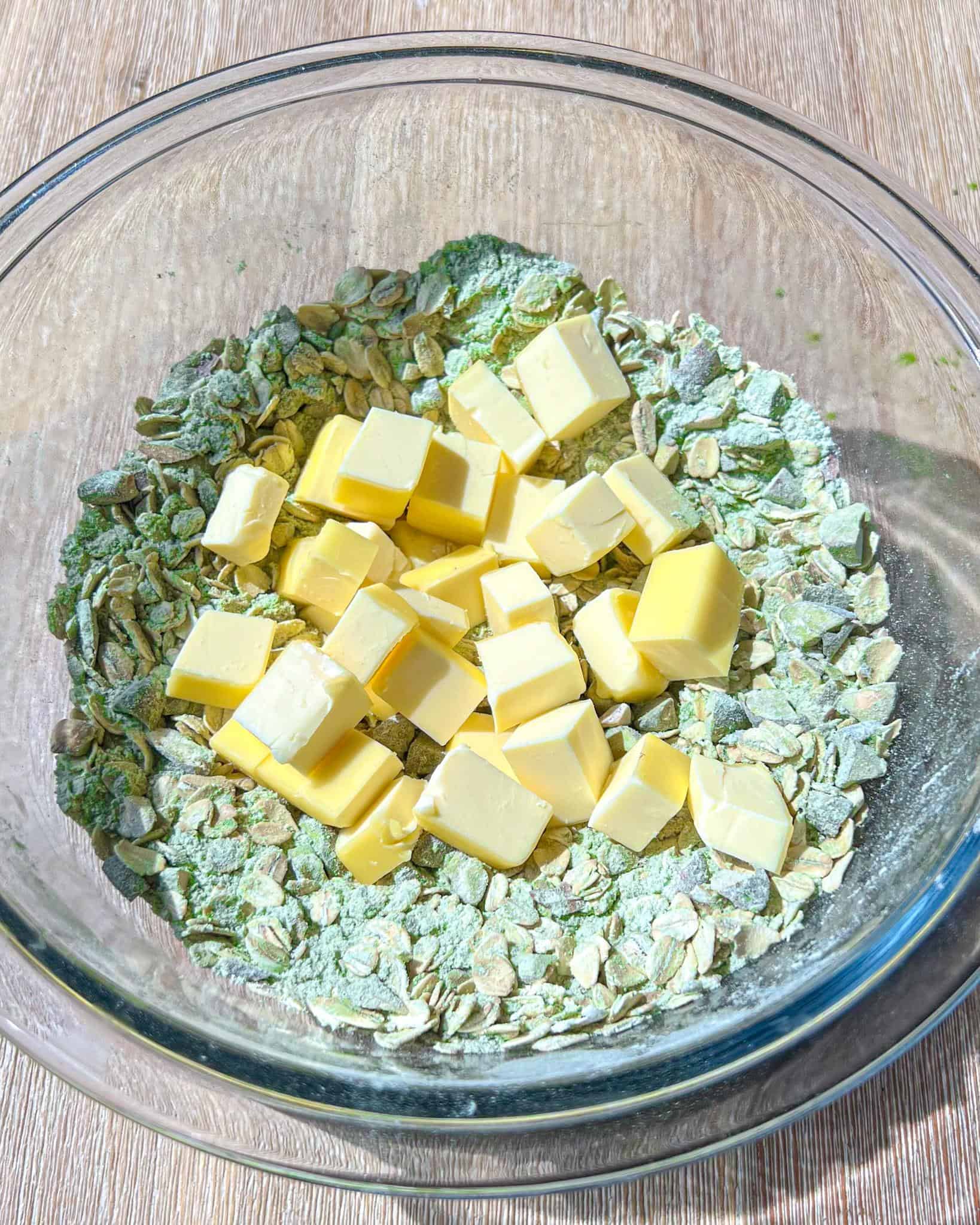 Easy Strawberry Matcha Crisp 5 Matcha crisp crumble dry ingredients with cold butter cubes in a glass bowl