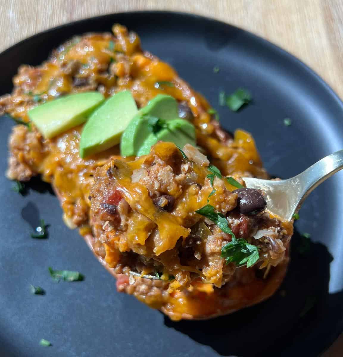 Spoonful of the turkey filling in the sweet potato boat