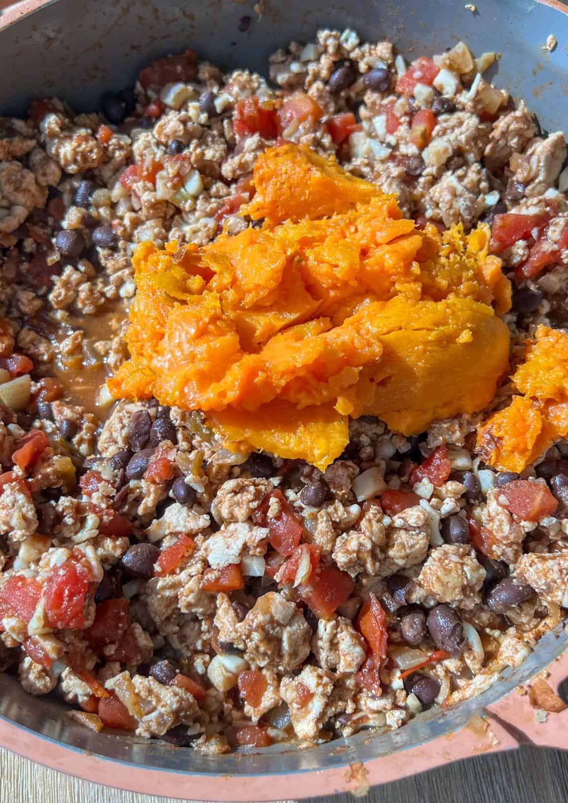 Turkey filling in a skillet with the sweet potato added in