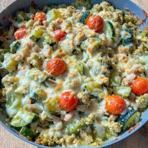 Pesto Chicken and White Bean Skillet 11 Skillet full of pesto with ground chicken, zucchini, tomatoes, and white beans topped with melted cheese