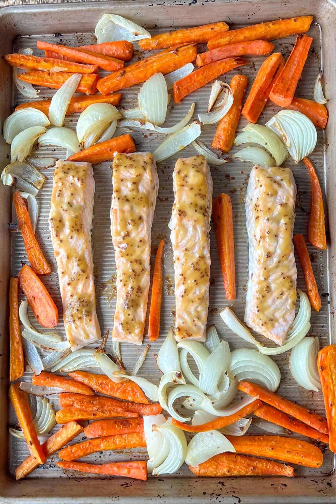 Honey Dijon Glazed Salmon 5 Honey dijon mustard glazed salmon on the sheet tray after being roasted and baked