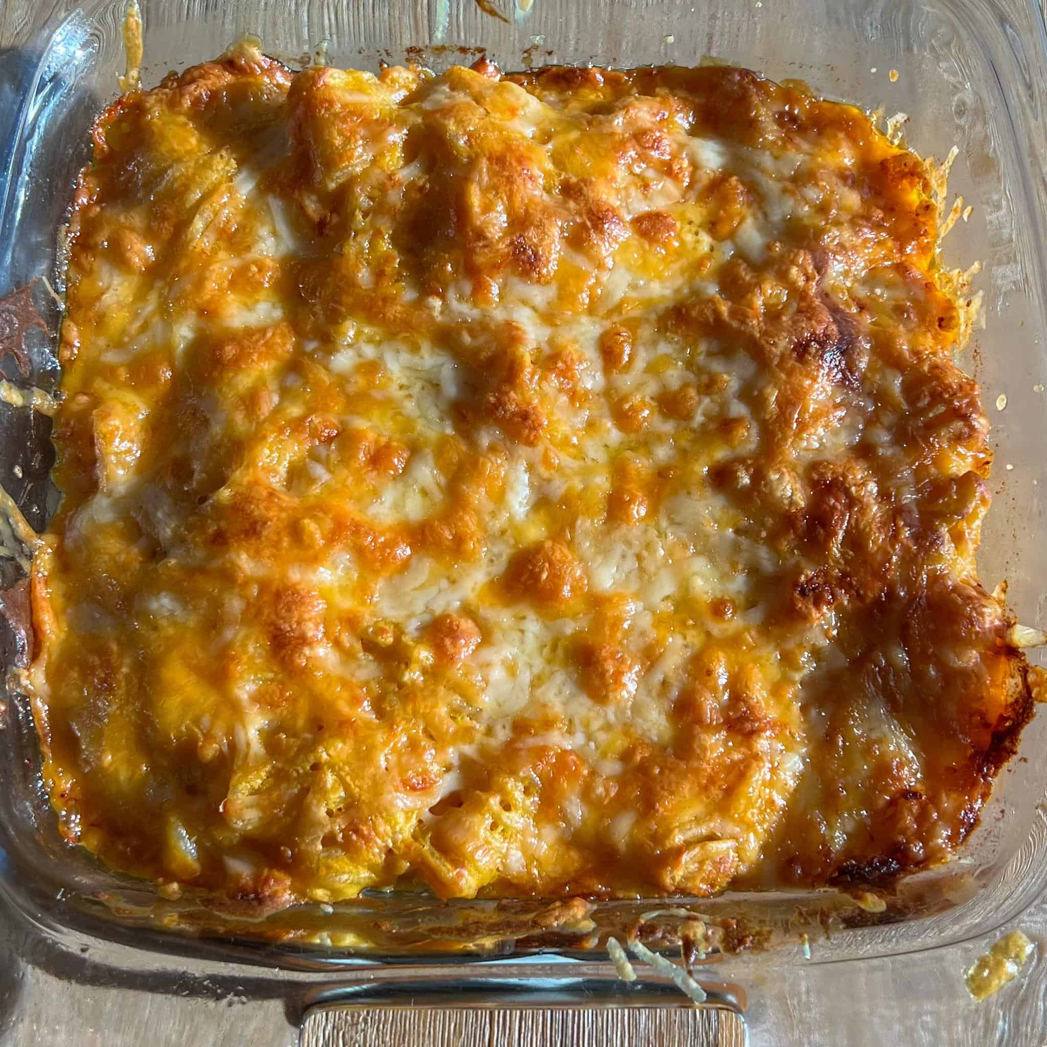 Baked Pumpkin Mac and Cheese 3 Baked pumpkin mac and cheese right out of the oven in a glass baking dish and a toasty cheesy layer on top.