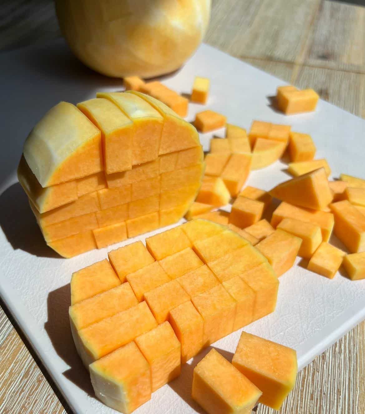 Hot Honey Butternut Squash Salad 3 Chopped butternut squash on a cutting board.