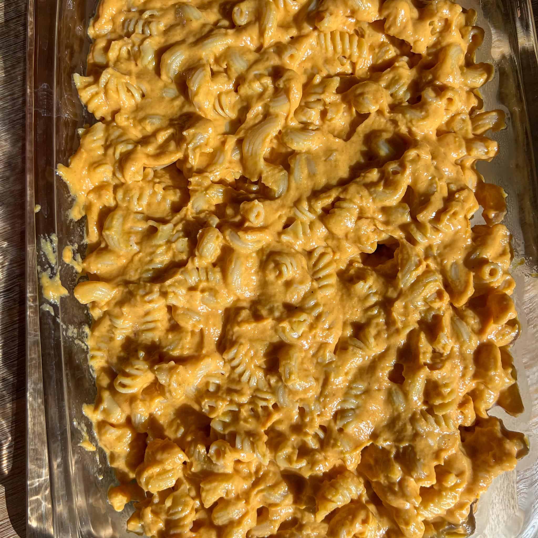 Baked Pumpkin Mac and Cheese 4 Glass baking dish full of pumpkin mac and cheese before being baked.