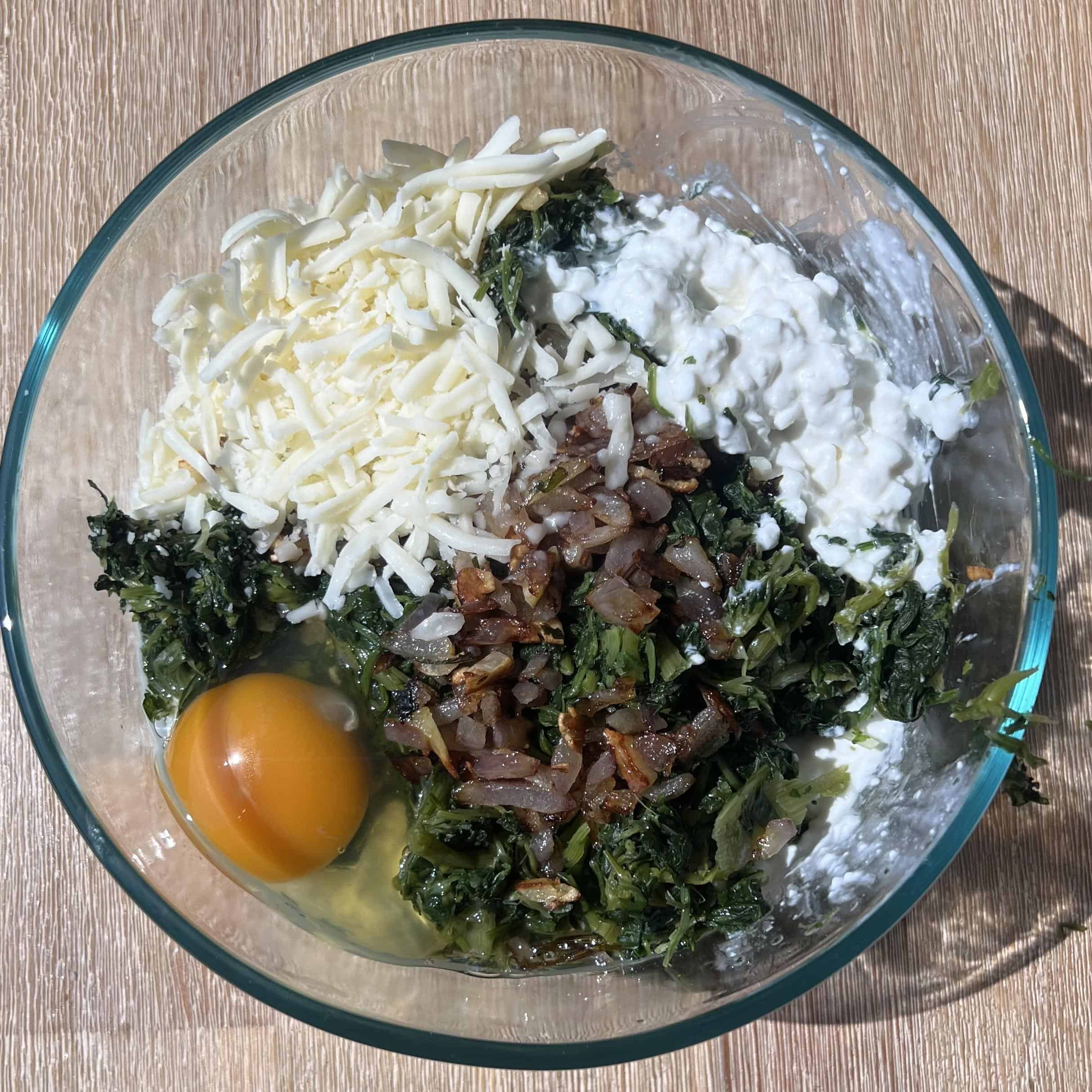 Butternut Squash and Spinach Lasagna Rollups 3 A glass bowl with all the spinach and cheese rollup filling.