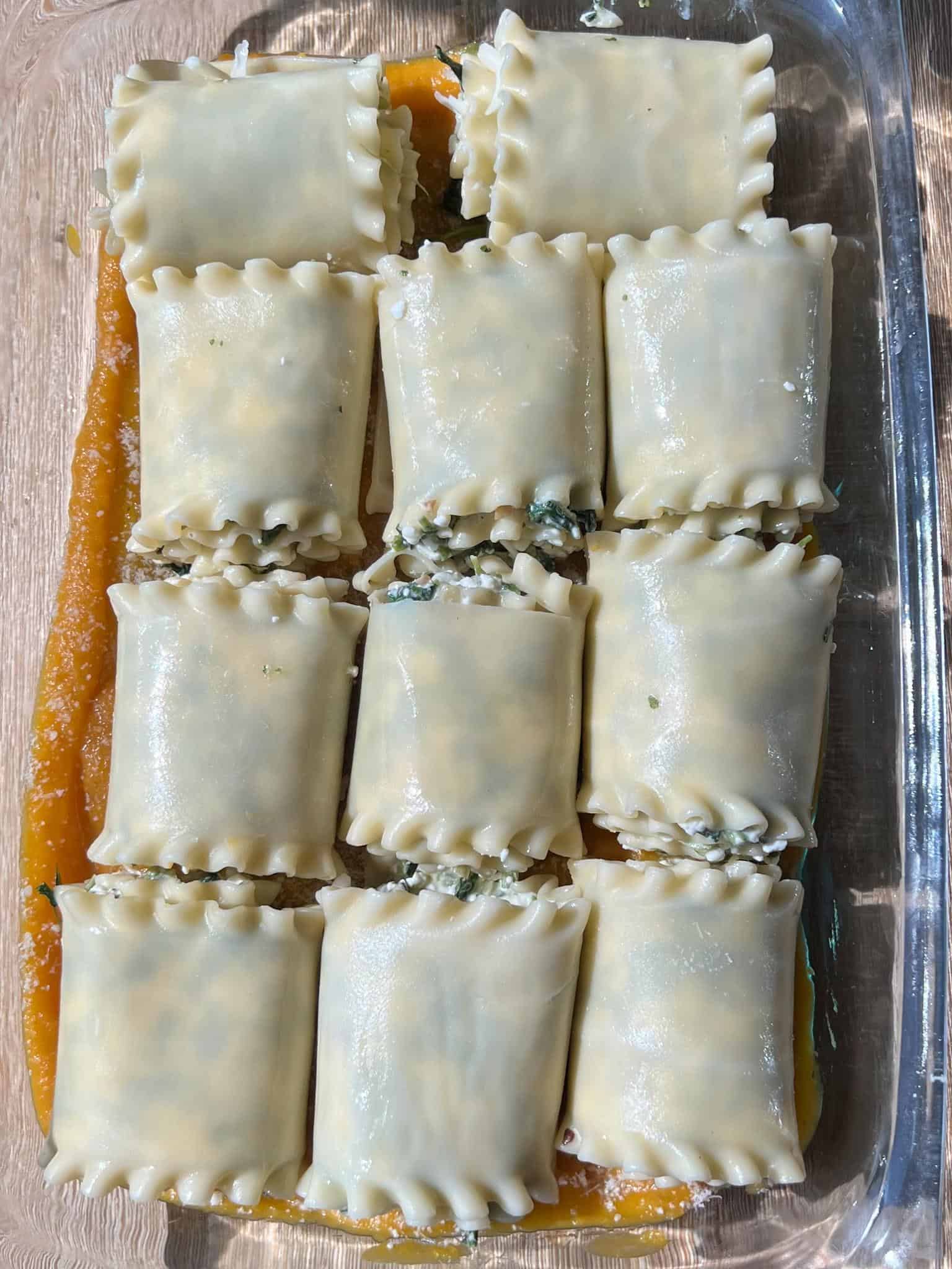 Butternut Squash and Spinach Lasagna Rollups 7 Baking dish full of the lasagna rollups before the butternut squash sauce and cheese poured over.