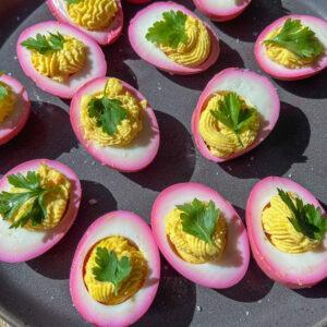 Passover Seder Deviled Eggs 7 Passover seder deviled eggs on a plate garnished with celery leaf