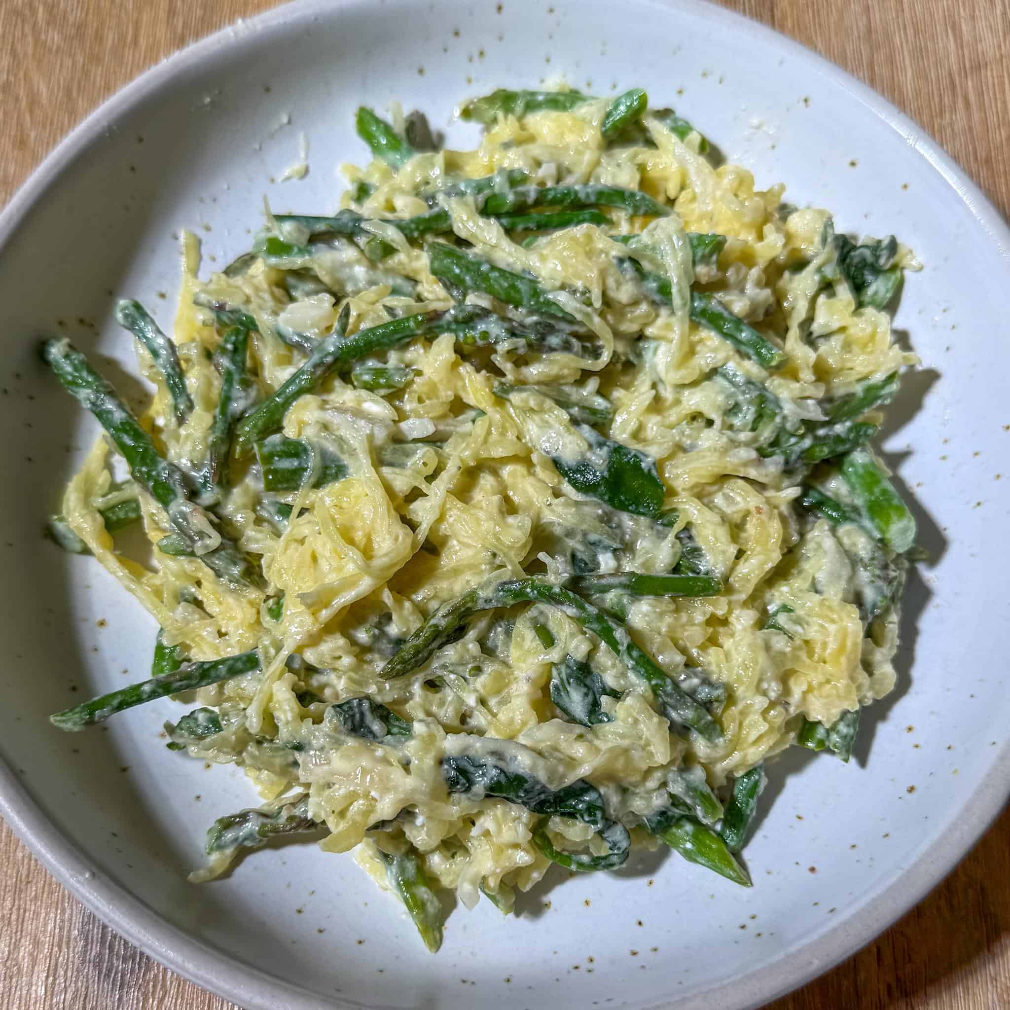 Healthy Spaghetti Squash Alfredo 3 easy, healthy, spaghetti squash Alfredo in a bowl with vegetables like spinach and asparagus.