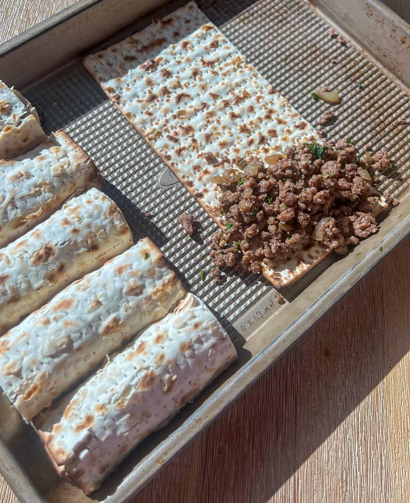 Matzo Cigars 4 Matzah laid out on a sheet tray with the filling, prior to rolling.