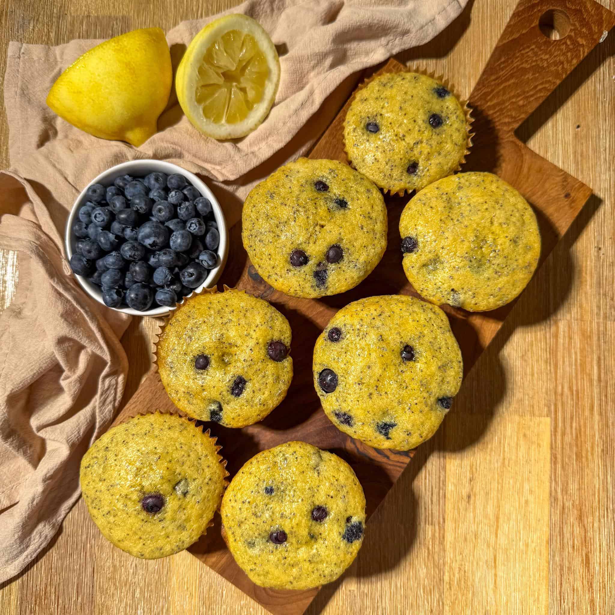 Blueberry Lemon Poppyseed Muffins 9 Unglazed lemon blueberry poppyseed muffins on a board