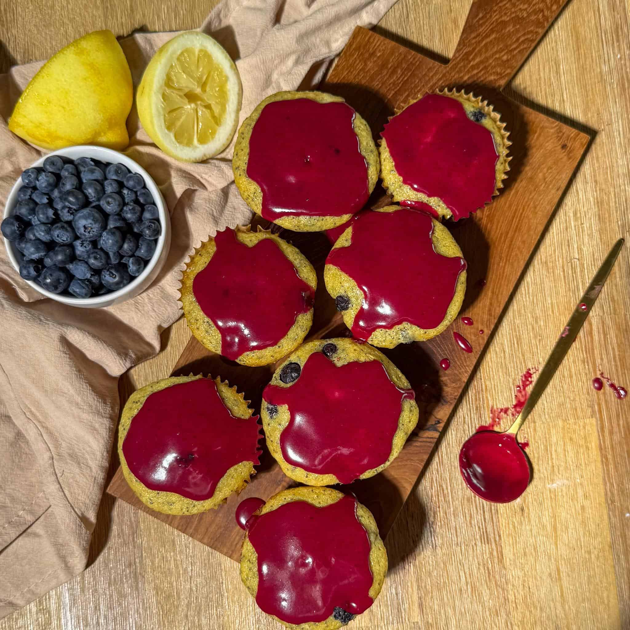 Blueberry Lemon Poppyseed Muffins 10 Glazed lemon poppy seed blueberry muffins on a serving board