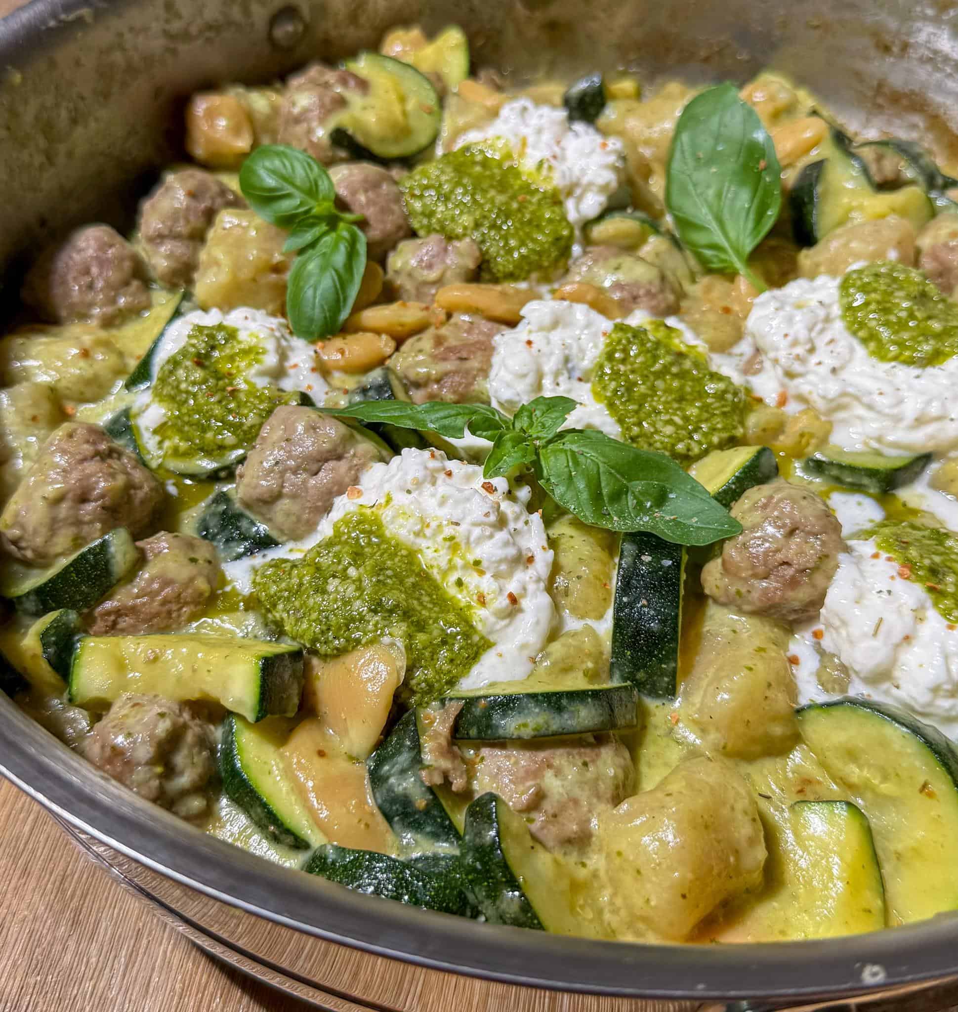 Healthy Pesto Gnocchi and Meatballs 3 Healthy cauliflower gnocchi and meatballs in a pan, garnished