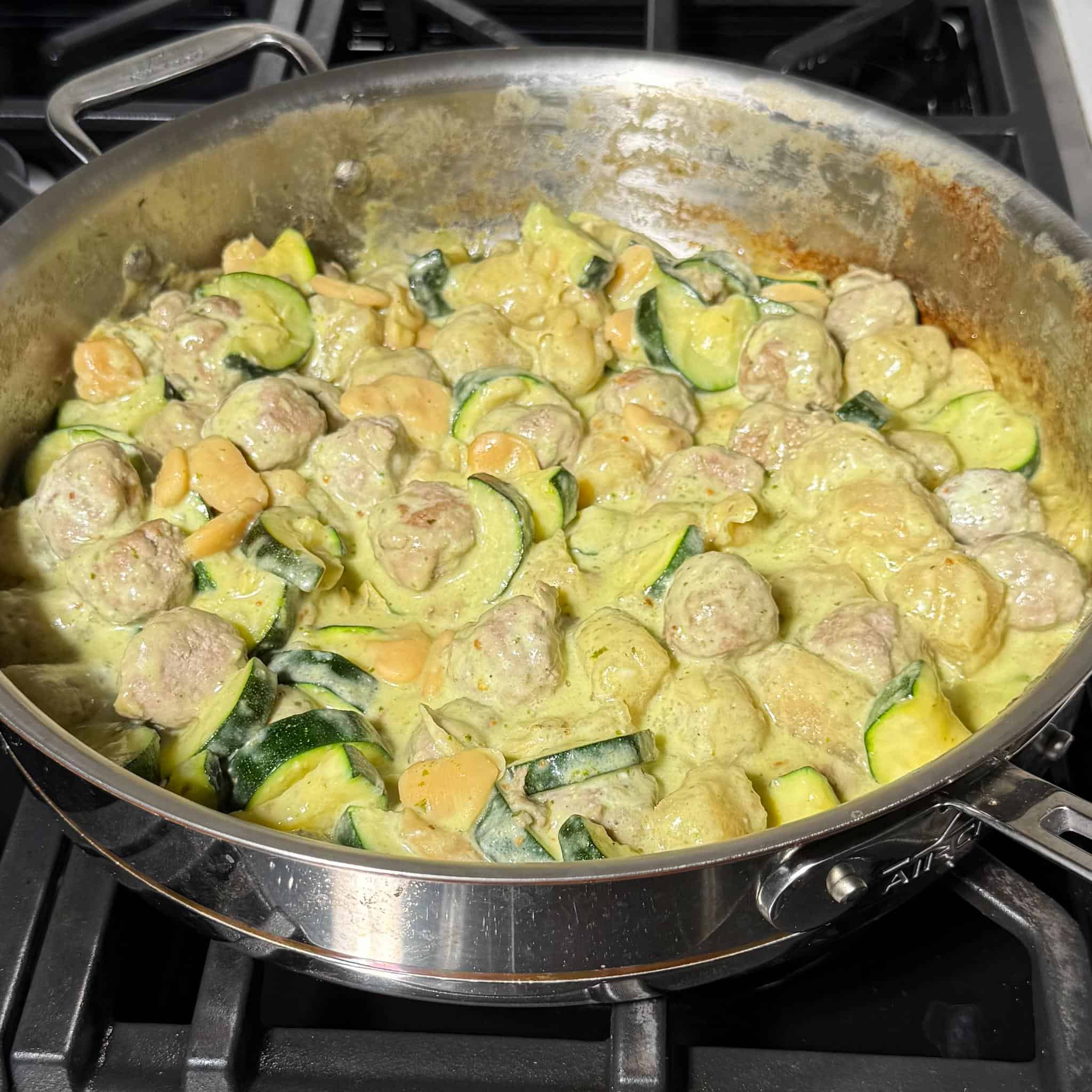 Healthy Pesto Gnocchi and Meatballs 8 Healthy creamy high protein pesto sauce added to the pan with all the ingredients