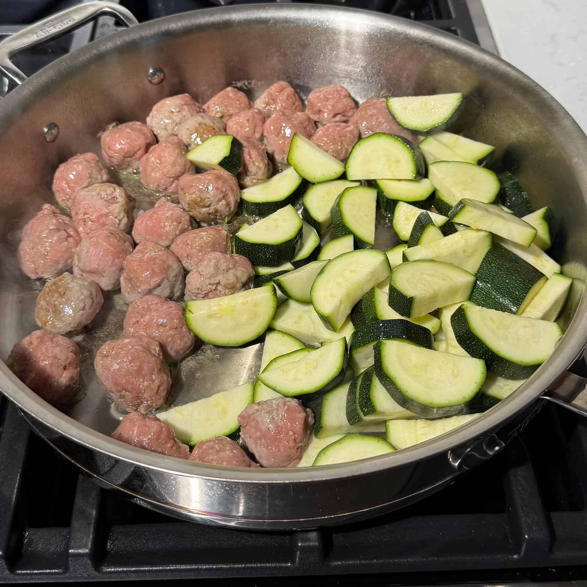 Healthy Pesto Gnocchi and Meatballs 5 Meatballs and zucchini just added to a pan on the stove