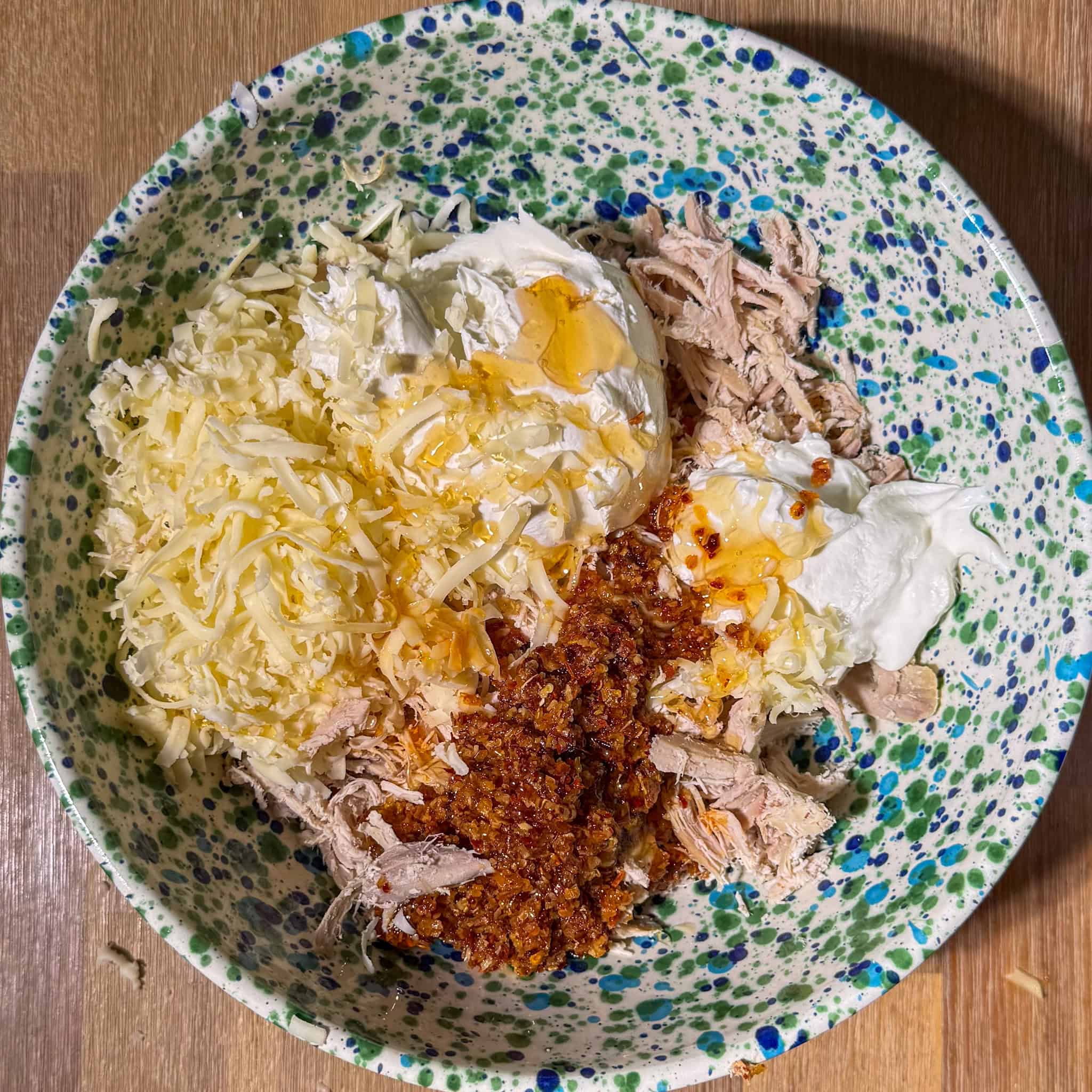 Cheesy Chili Crisp Honey Chicken dip 4 Most ingredients for the dip in a bowl.