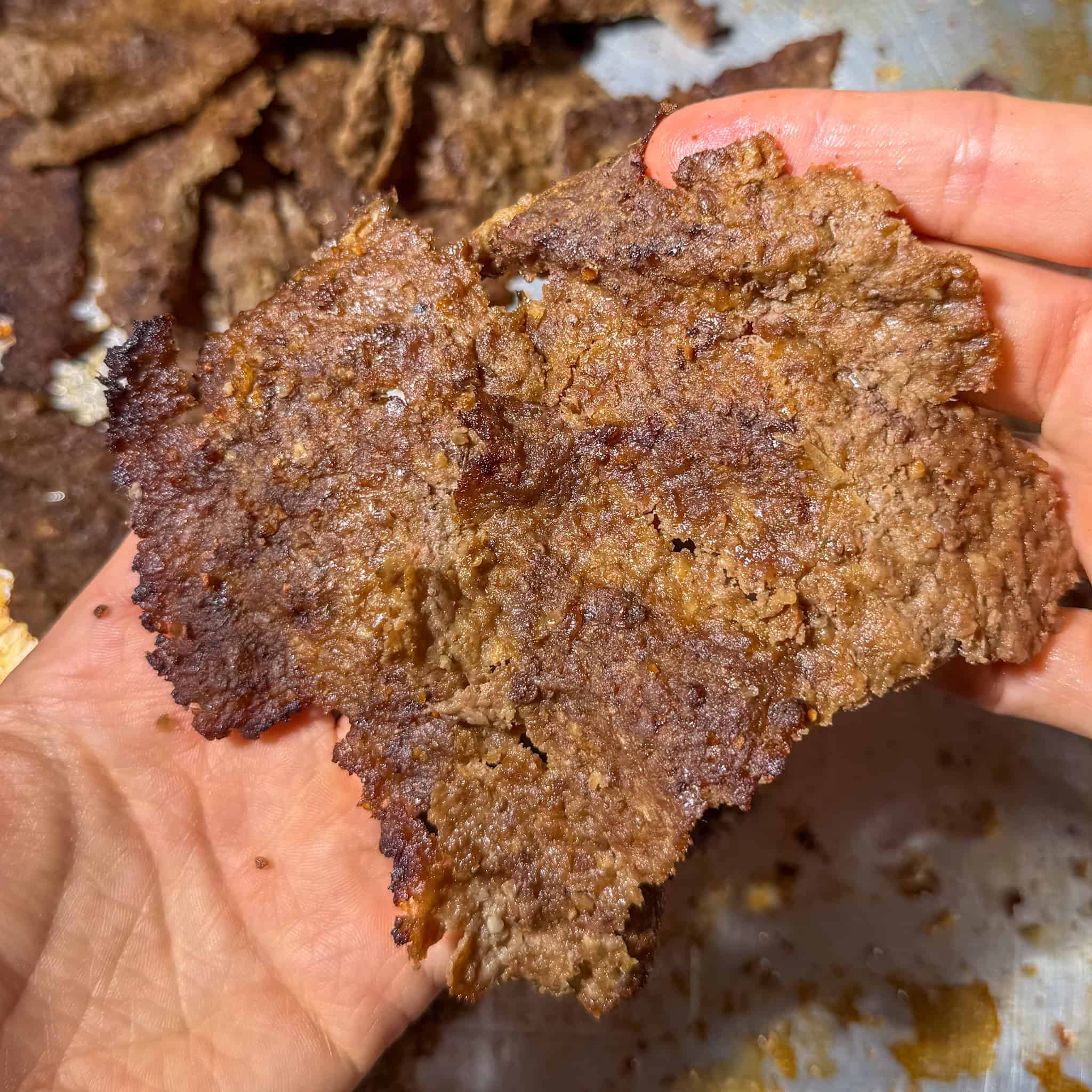 Close-up of the viral oven baked doner kebabs held in two hands.