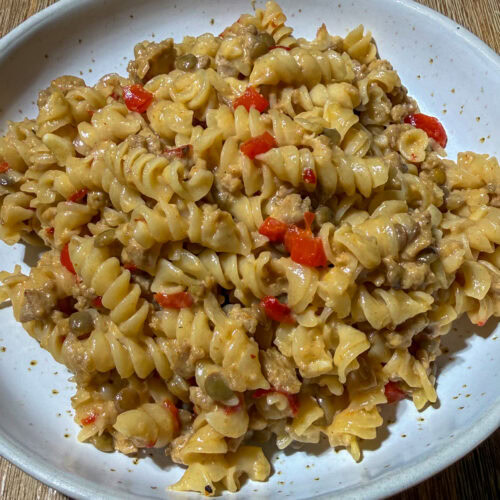 High-Fiber Cheesy Taco Pasta 5 Plate of high fiber pasta with turkey taco meat, a lot of cheese, vegetables, and lentils or beans.