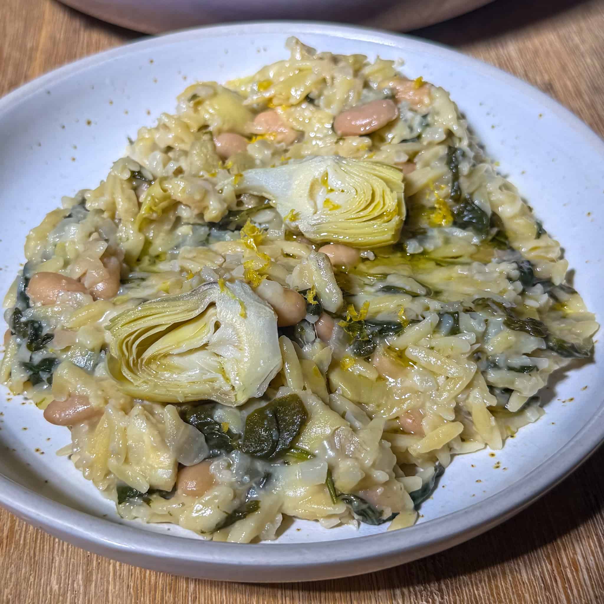 Plate of high fiber spinach artichoke orzo