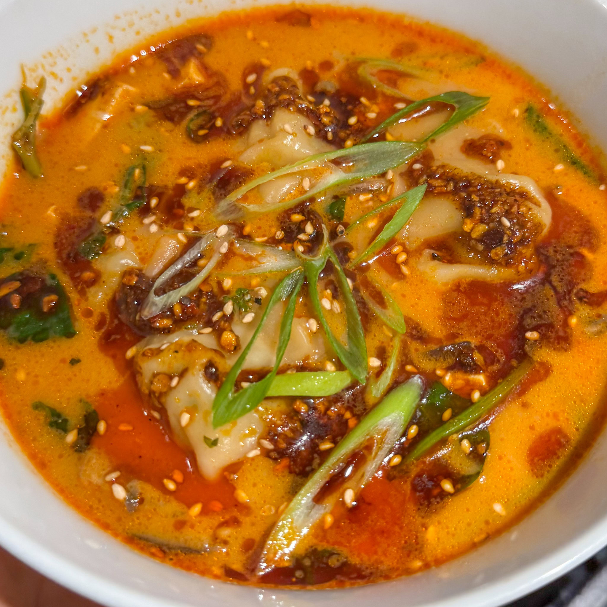 Bowl of red curry dumpling soup