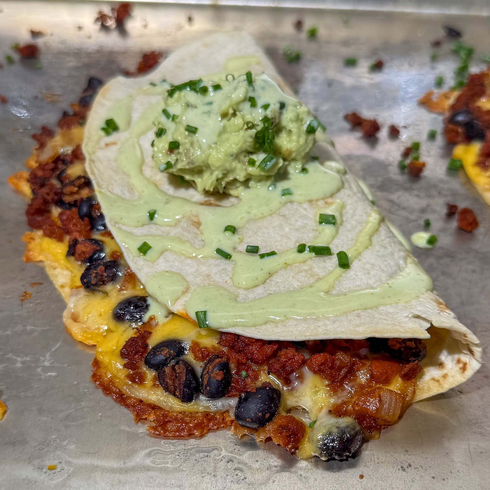 Black bean and soyrizo tacos baked, with guacamole and salsa on top