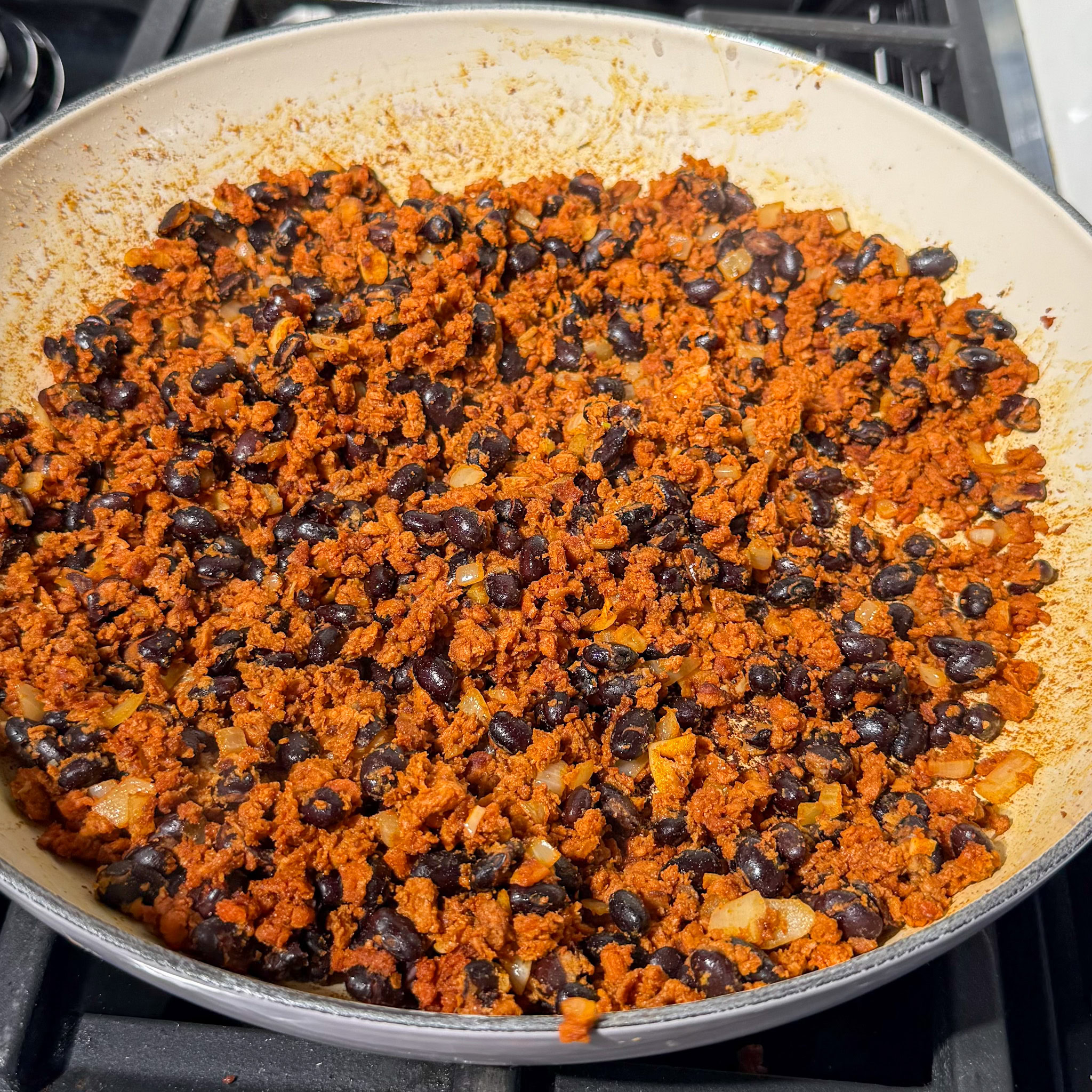 Black beans and soyrizo in a pan cooked and mixed together