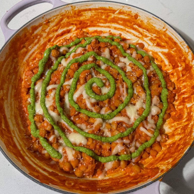 Best tie dye pizza beans in a skillet with pesto swirled on top