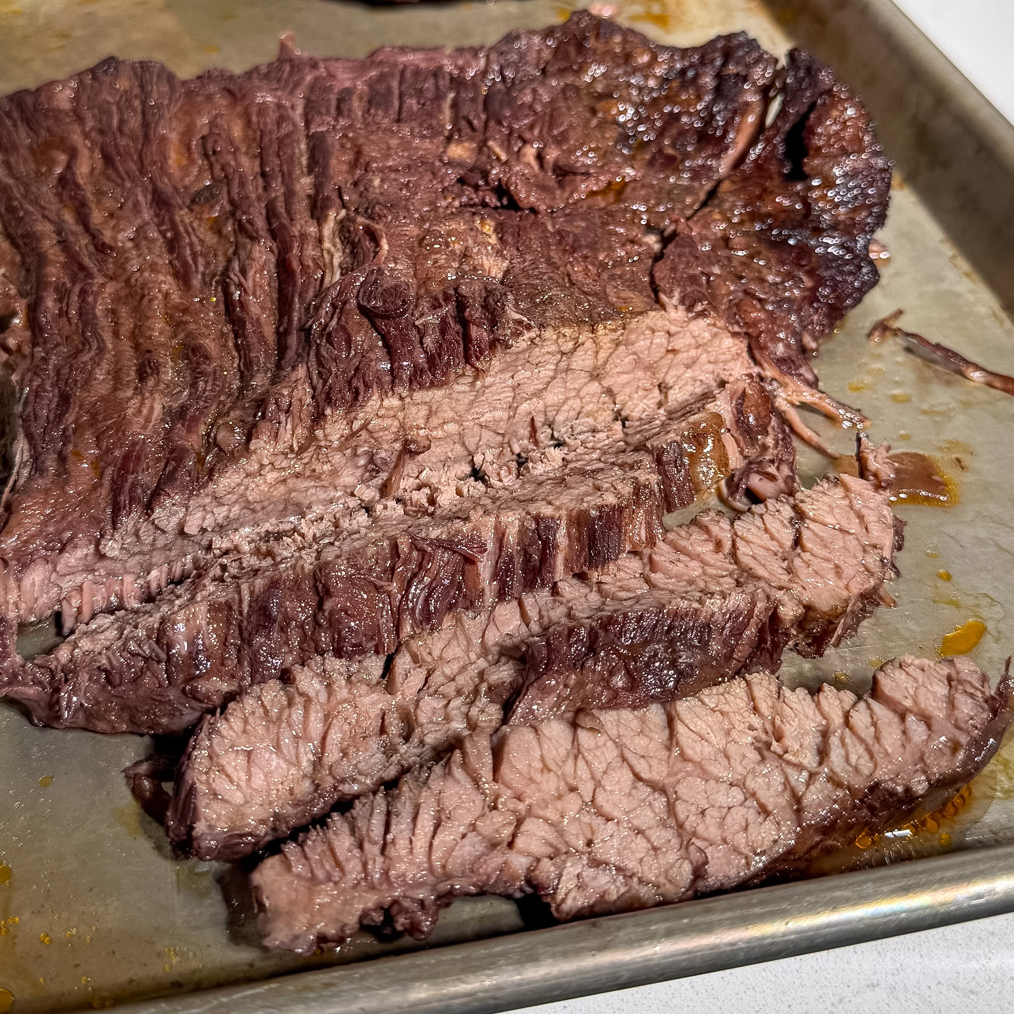 Red Wine Braised Brisket 10 Sliced brisket against the grain on a cutting board