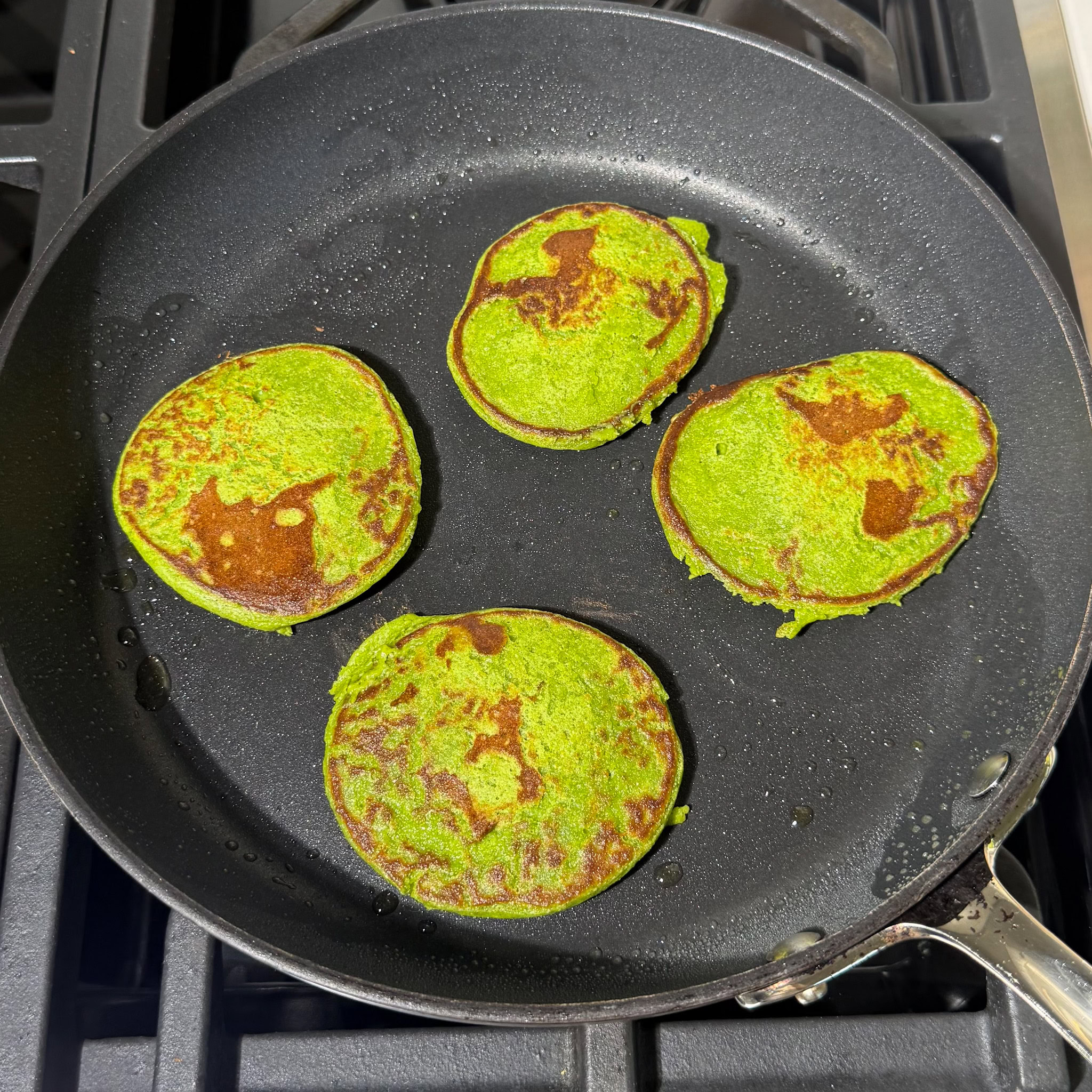 cooking pancakes on a skillet, after  flipping