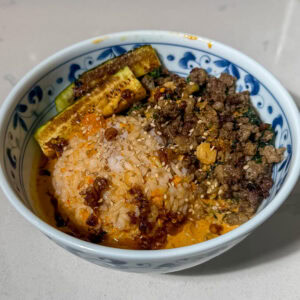 Viral brothy rice bowls with a curry sauce and ground beef with vegetables in a bowl